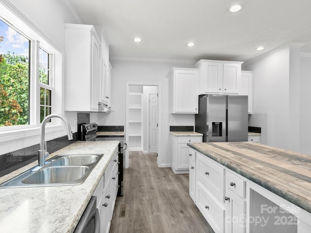 207 Walnut Branch Rd, Weaverville, NC 28787 - kitchen with appliances with stainless steel finishes, ornamental molding, white cabinetry, light wood-type flooring, and recessed lighting