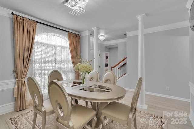 2026 Rosewater Ln, Indian Trail, NC 28079 - dining room with decorative columns, light wood-style floors, ornamental molding, and stairway