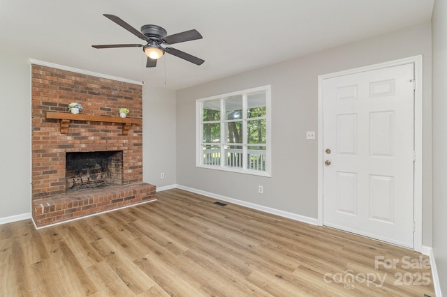1118 Brookwood Dr, Stanley, NC 28164 - unfurnished living room with wood finished floors, a brick fireplace, and a ceiling fan
