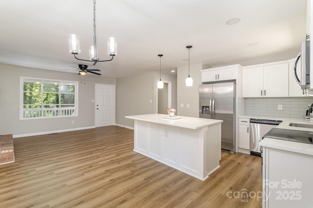 1118 Brookwood Dr, Stanley, NC 28164 - kitchen with stainless steel appliances, ceiling fan, light wood-type flooring, decorative backsplash, and light countertops