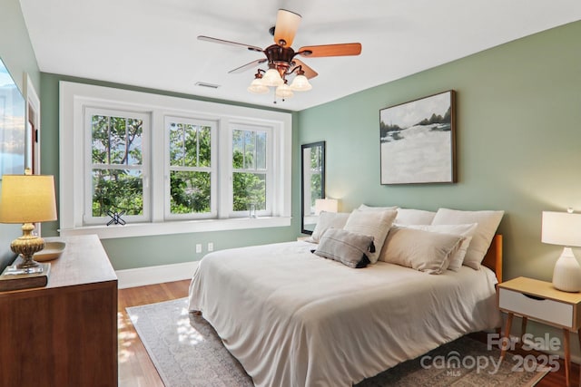 203 6th Ave W Unit 2A, Hendersonville, NC 28739 - bedroom with multiple windows, wood finished floors, and a ceiling fan
