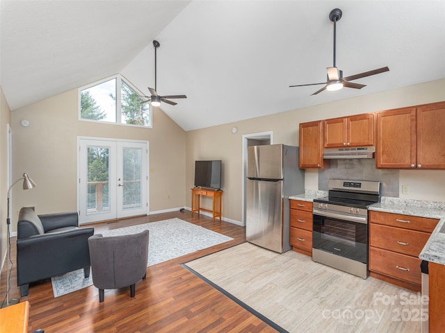 286 Keith Dr, Canton, NC 28716 - kitchen featuring stainless steel appliances, ceiling fan, under cabinet range hood, brown cabinetry, and high vaulted ceiling
