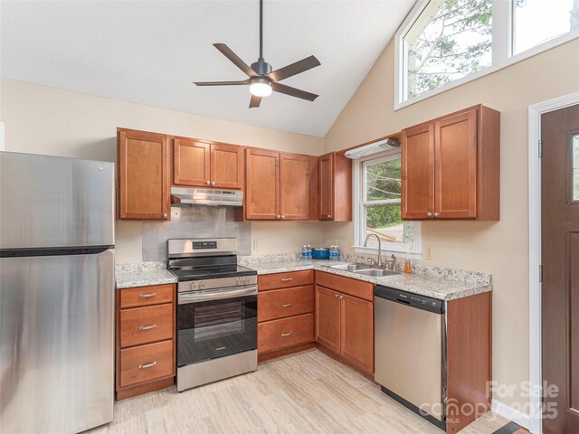 286 Keith Dr, Canton, NC 28716 - kitchen with stainless steel appliances, under cabinet range hood, brown cabinets, a ceiling fan, and high vaulted ceiling