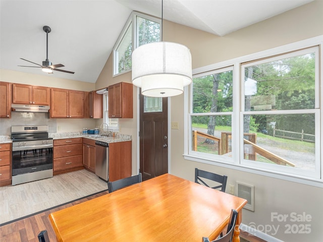 286 Keith Dr, Canton, NC 28716 - kitchen with stainless steel appliances, under cabinet range hood, brown cabinetry, light wood finished floors, and light countertops