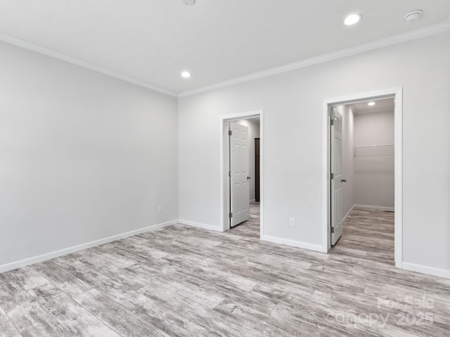 208 Walnut Branch Rd, Weaverville, NC 28787 - unfurnished bedroom featuring ornamental molding, a spacious closet, recessed lighting, light wood-style floors, and a closet