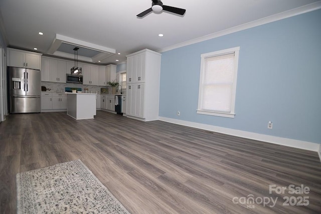 305 E Henry St, Belmont, NC 28012 - unfurnished living room with crown molding, healthy amount of natural light, a tray ceiling, ceiling fan, and recessed lighting