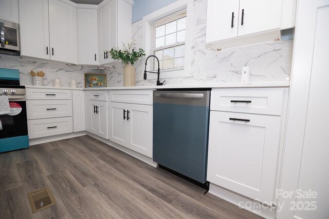 305 E Henry St, Belmont, NC 28012 - kitchen featuring stainless steel appliances, decorative backsplash, white cabinets, and dark wood-type flooring