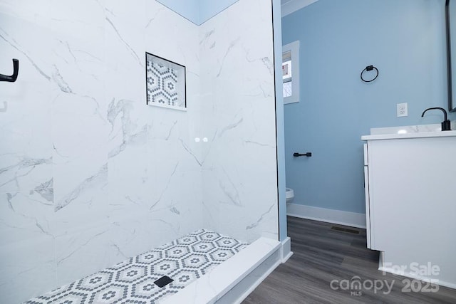 305 E Henry St, Belmont, NC 28012 - bathroom with vanity, a marble finish shower, and wood finished floors