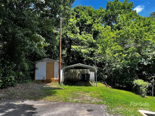 305 E Henry St, Belmont, NC 28012 - view of yard with a storage unit and a detached carport