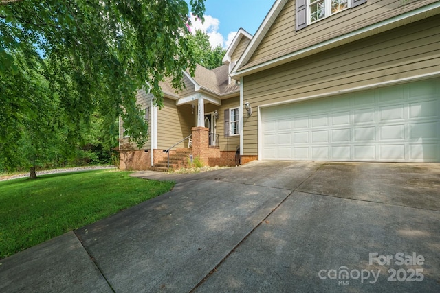 206 Taylor Cir, Granite Falls, NC 28630 - view of front of house featuring concrete driveway, a front lawn, and a garage