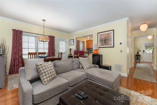 115 White Ash Dr Unit E, Asheville, NC 28801 - living area with light wood finished floors, crown molding, and healthy amount of natural light