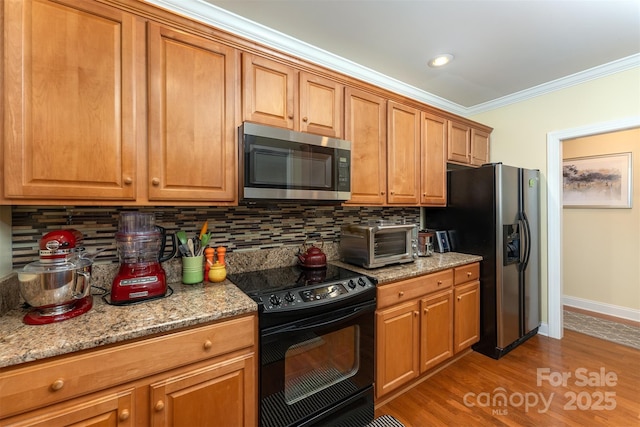 115 White Ash Dr Unit E, Asheville, NC 28801 - kitchen with stainless steel microwave, electric range, refrigerator with ice dispenser, ornamental molding, and tasteful backsplash