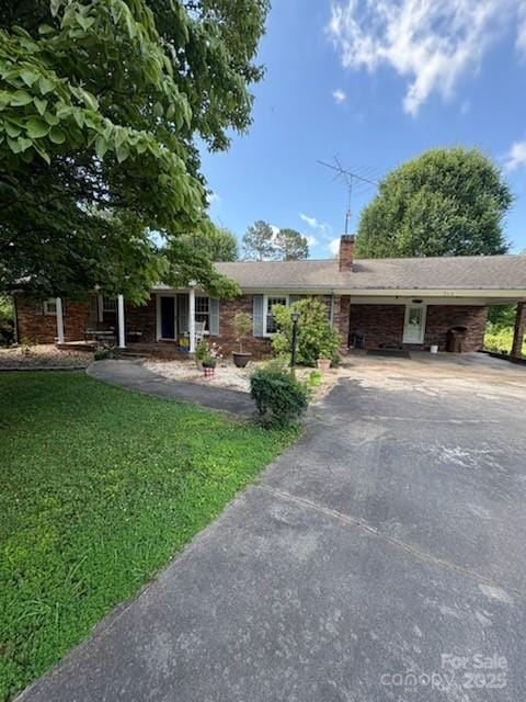 315 Terrace Pl Unit 9, Lincolnton, NC 28092 - ranch-style house featuring driveway, a front lawn, a chimney, and an attached carport