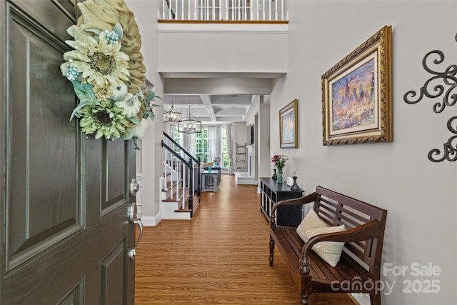 3020 Waxhaw Crossing Dr, Waxhaw, NC 28173 - foyer featuring coffered ceiling, wood finished floors, stairway, beam ceiling, and a chandelier