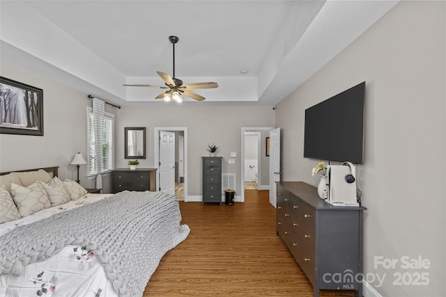3020 Waxhaw Crossing Dr, Waxhaw, NC 28173 - bedroom featuring wood finished floors, a raised ceiling, and ceiling fan