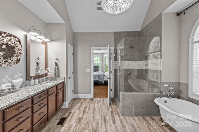 3020 Waxhaw Crossing Dr, Waxhaw, NC 28173 - bathroom with a freestanding bath, vanity, a stall shower, lofted ceiling, and ensuite bathroom