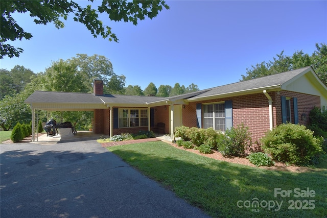141 Azalea Dr, Connelly Springs, NC 28612 - single story home with driveway, a chimney, an attached carport, brick siding, and a front yard