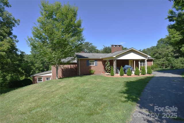 141 Azalea Dr, Connelly Springs, NC 28612 - view of front of property featuring a front lawn, a chimney, and brick siding
