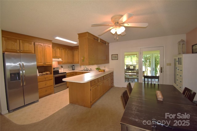 141 Azalea Dr, Connelly Springs, NC 28612 - kitchen with appliances with stainless steel finishes, a peninsula, under cabinet range hood, ceiling fan, and light countertops