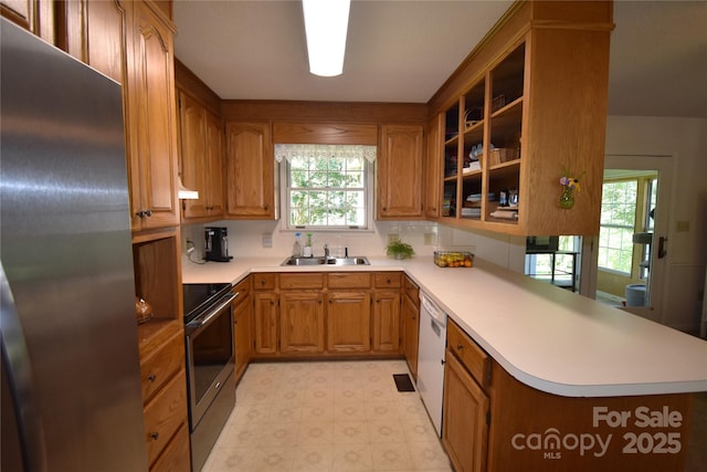 141 Azalea Dr, Connelly Springs, NC 28612 - kitchen with freestanding refrigerator, range, white dishwasher, light countertops, and plenty of natural light