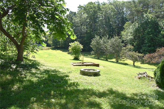 141 Azalea Dr, Connelly Springs, NC 28612 - view of grassy yard with an outdoor fire pit