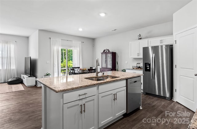 192 Culloden Dr, Mocksville, NC 27028 - kitchen featuring appliances with stainless steel finishes, dark wood-type flooring, an island with sink, light stone counters, and white cabinets