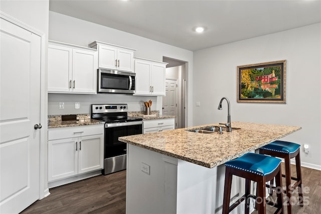 192 Culloden Dr, Mocksville, NC 27028 - kitchen featuring appliances with stainless steel finishes, dark wood-style floors, light stone counters, a kitchen bar, and recessed lighting