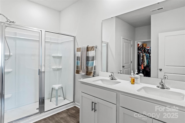 192 Culloden Dr, Mocksville, NC 27028 - full bathroom featuring a stall shower, double vanity, wood finished floors, and a spacious closet