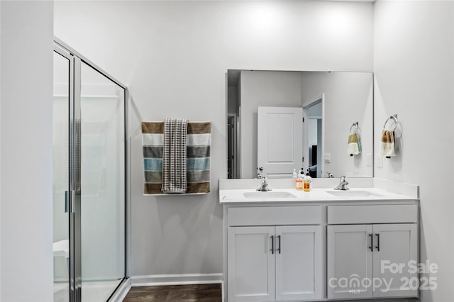 192 Culloden Dr, Mocksville, NC 27028 - full bathroom with double vanity, a shower stall, and wood finished floors