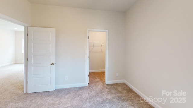 608 Banter Ln Unit 31, Cramerton, NC 28032 - unfurnished bedroom featuring carpet floors, a walk in closet, and a closet