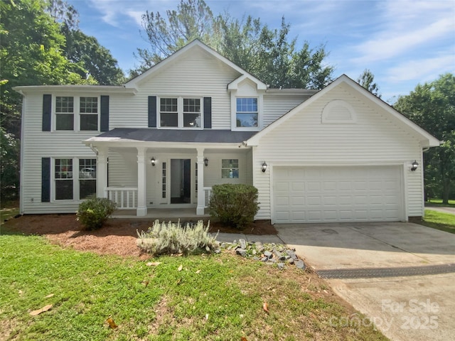 424 Mallard Dr, Pineville, NC 28134 - traditional-style house with covered porch, a garage, concrete driveway, and a front lawn