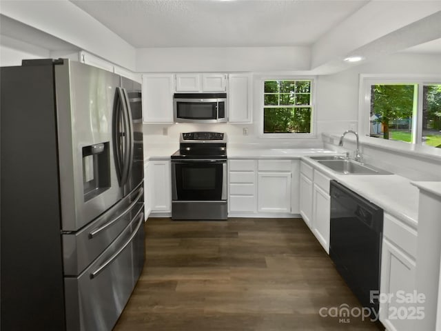 424 Mallard Dr, Pineville, NC 28134 - kitchen with appliances with stainless steel finishes, light countertops, white cabinetry, and dark wood-style floors