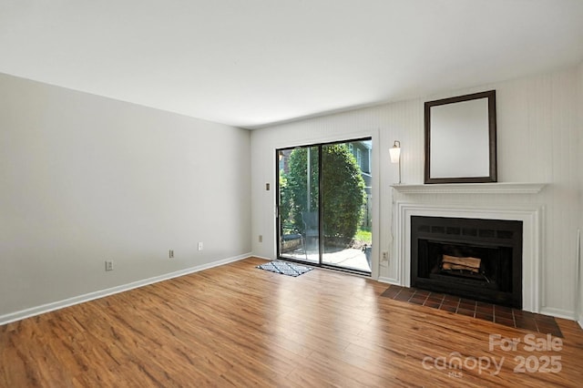 3020 Heathstead Pl Unit A, Charlotte, NC 28210 - unfurnished living room featuring wood finished floors and a fireplace with flush hearth