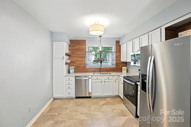 3020 Heathstead Pl Unit A, Charlotte, NC 28210 - kitchen with stainless steel appliances, white cabinets, light countertops, and decorative light fixtures