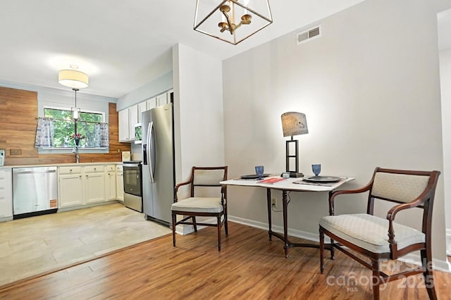 3020 Heathstead Pl Unit A, Charlotte, NC 28210 - living area with light wood finished floors, a chandelier, and a desk