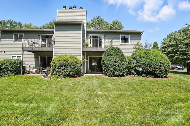 3020 Heathstead Pl Unit A, Charlotte, NC 28210 - back of house featuring a balcony, a lawn, and a chimney