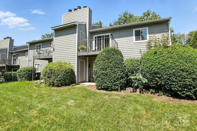 3020 Heathstead Pl Unit A, Charlotte, NC 28210 - rear view of property with a chimney, a yard, and a balcony