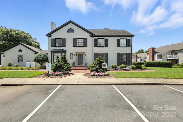 3020 Heathstead Pl Unit A, Charlotte, NC 28210 - view of front of property with uncovered parking, a chimney, and a front lawn