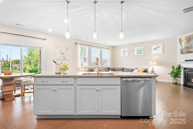 4116 Tory Path Rd, Waxhaw, NC 28173 - kitchen featuring dishwasher, open floor plan, wood finished floors, and hanging light fixtures
