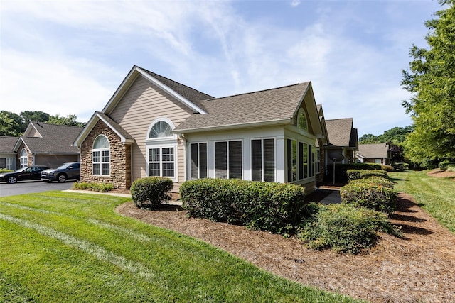 6811 Ledgestone Pl, Charlotte, NC 28227 - view of front of property featuring stone siding, a front lawn, and roof with shingles