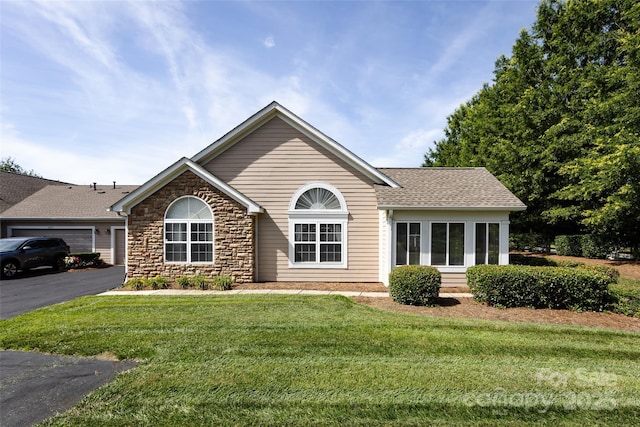 6811 Ledgestone Pl, Charlotte, NC 28227 - ranch-style home featuring a front lawn, stone siding, roof with shingles, and asphalt driveway
