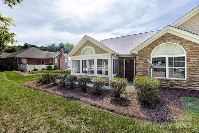 6811 Ledgestone Pl, Charlotte, NC 28227 - view of front of house featuring stone siding, a front yard, and roof with shingles
