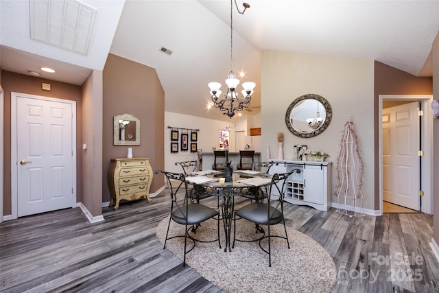 6811 Ledgestone Pl, Charlotte, NC 28227 - dining room featuring wood finished floors, a chandelier, and high vaulted ceiling
