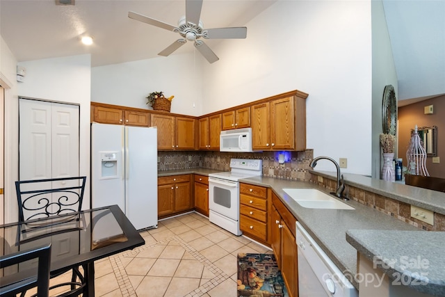 6811 Ledgestone Pl, Charlotte, NC 28227 - kitchen with white appliances, high vaulted ceiling, light tile patterned flooring, backsplash, and ceiling fan