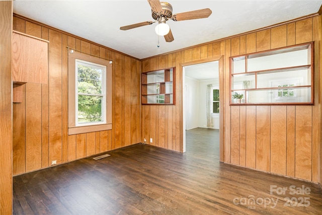 3425 Long Ferry Rd, Salisbury, NC 28146 - empty room with wood finished floors, ornamental molding, wooden walls, and a ceiling fan