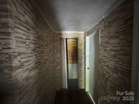 127 Hill St, Mooresboro, NC 28114 - corridor featuring a textured ceiling