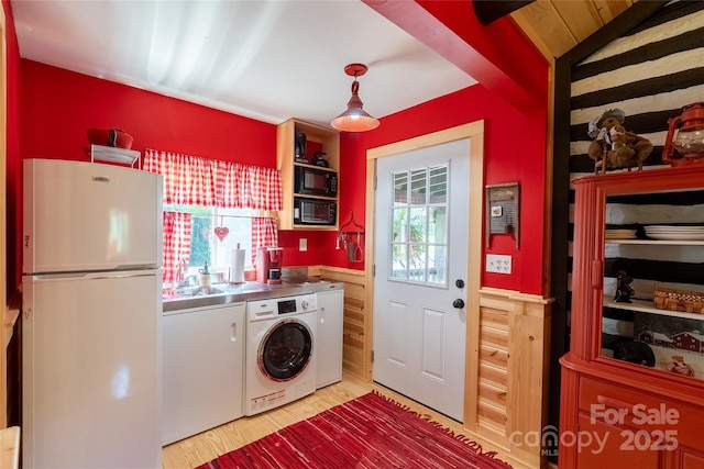 225 Wilderness Rd, Tryon, NC 28782 - kitchen with freestanding refrigerator, washer / dryer, stainless steel countertops, a wainscoted wall, and light wood finished floors