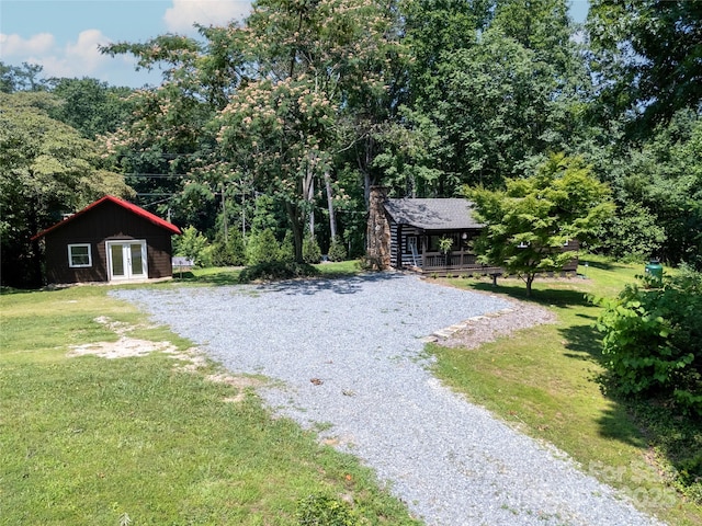 225 Wilderness Rd, Tryon, NC 28782 - view of grassy yard featuring french doors and a view of trees