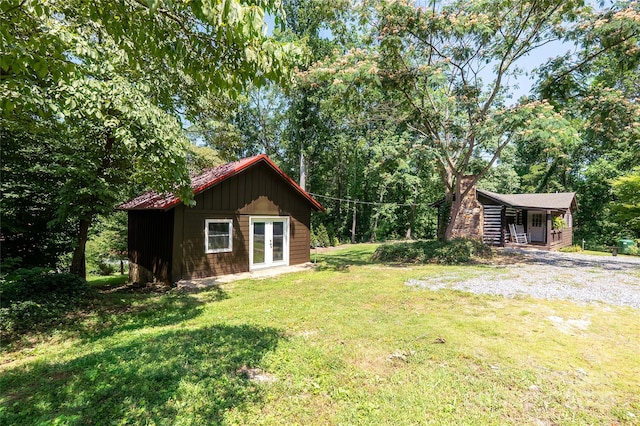 225 Wilderness Rd, Tryon, NC 28782 - view of grassy yard with an outbuilding and french doors
