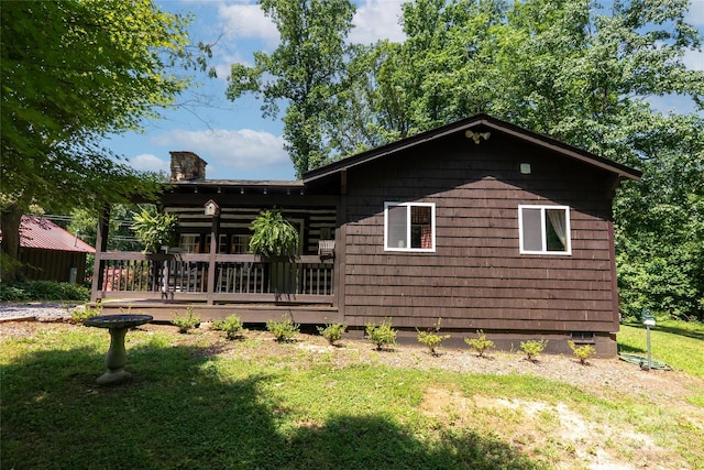 225 Wilderness Rd, Tryon, NC 28782 - rear view of property featuring a yard, a deck, and a chimney